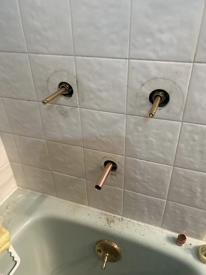 Residential plumbing work near a utility area